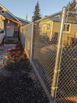 Installation of galvanized chain link fencing — Landscape Construction project by All Seasons Landscaping Of Mason County LLC