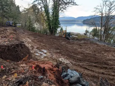 Installation of a rock retaining wall and parking area — Landscape Construction project by All Seasons Landscaping Of Mason County LLC