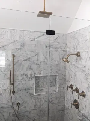 Contemporary primary bathroom featuring marble tiles, barrier-free shower, and bespoke vanity — Home Renovation & Remodeling Services project by Prime & Precision