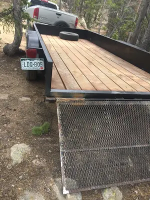 Revamped flatbed trailer with fresh paint and a custom fold-down gate — Home Renovation & Remodeling Services project by Big Horn Construction, LTD