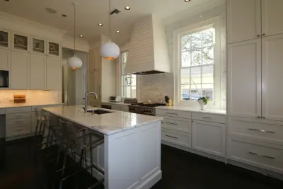 Contemporary Design with Custom Hood, Marble Countertops, and White Cabinets — Kitchen Remodeling project by Classic Cupboards, Inc