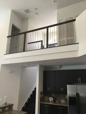 Coconut Creek, FL - Upright Stainless Steel Rods with Solid Red Oak Handrail — Carpentry & Woodworking project by Alpha Woodwork Inc.
