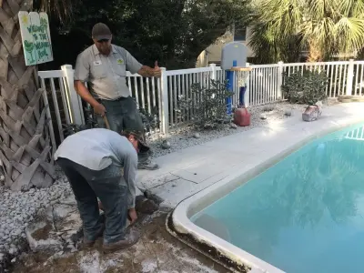 Emerald Isle pool makeover - converting old concrete deck to travertine by Yardworks, Inc.