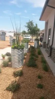 Metal Flower Pipe Planters — Landscape Design project by Austex Landscape