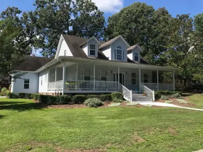 Porch-Encircled Farmhouse by Patriot Roofing Company