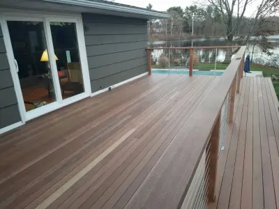Tailored Mahogany Deck Featuring CableRail System — Roofing & Gutter Services project by Loyalty Exterior Solutions
