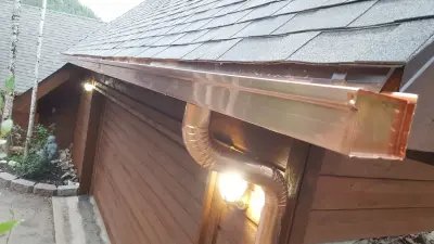 Sustainable Copper Box Gutter and Round Copper Downspout — Roofing & Gutter Services project by Precision Seamless Gutters LLC