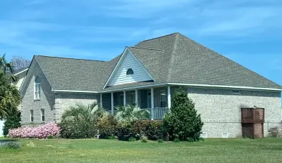 Gray Brick Residence — Roofing & Gutter Services project by Patriot Roofing Company