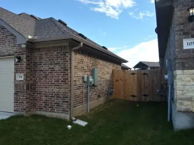 Gutter Setup on Brick House in Hutto, TX — Roofing & Gutter Services project by Gutter Tex