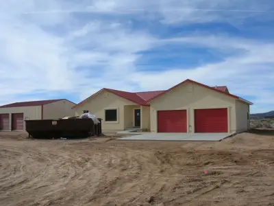 Cedar City, UT Home with Metal Roof and Stucco — Roofing & Gutter Services project by Sideone Exteriors