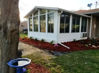 Installation of siding, windows, and a sunroom for residents in Joyce, Iowa — Roofing & Gutter Services project by Midwest Construction & Supply INC