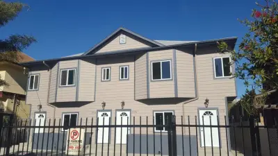 Gray Stone New Rain Gutters — Roofing & Gutter Services project by SLR Roofing