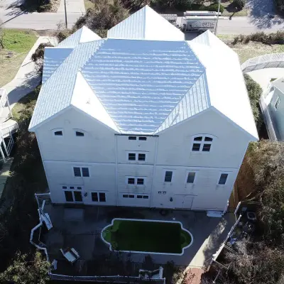 White Metal Roofing on a Stunning Emerald Isle, NC Coastal Home — Roofing & Gutter Services project by McCarthy Metal Roofing
