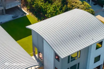 Curved Zinc Roof Oceanfront Residence – Figure Eight Island, NC — Roofing & Gutter Services project by Flores & Foley Roofing + Sheet Metal