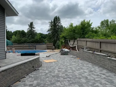 Large pool patio and wall with raised patio — Landscape Construction project by South Metro Lawn And Landscape